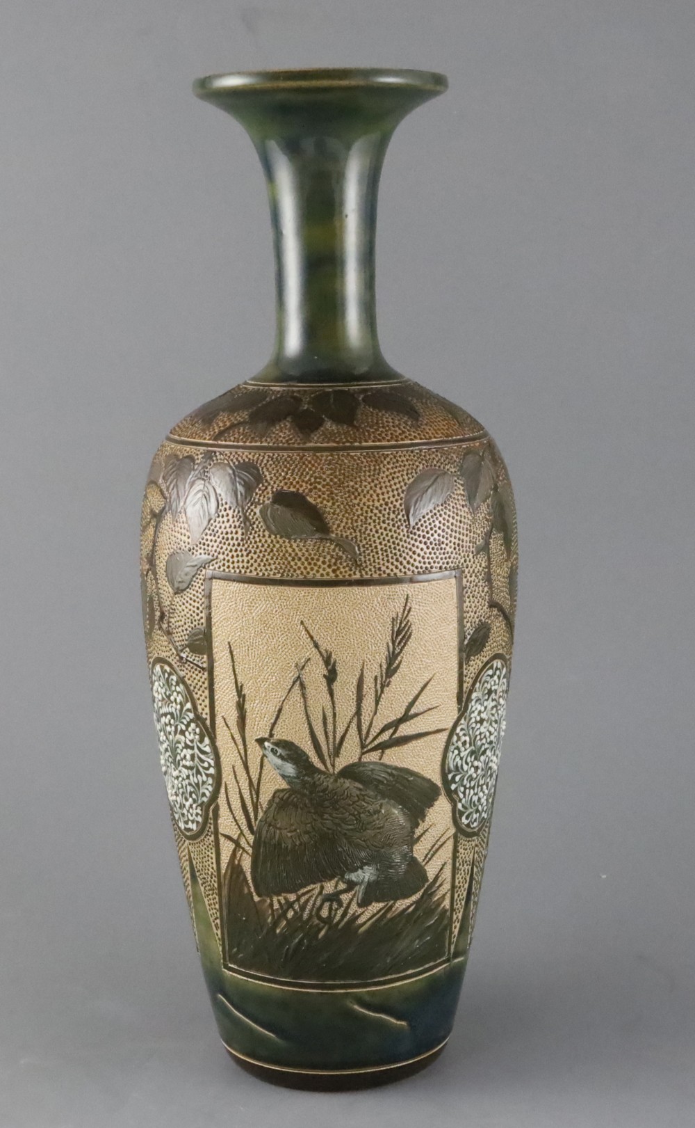 Florence E Barlow for Doulton Lambeth, a large pate sur pate partridge vase, dated 1884, with three panels on leaf and floral ground,